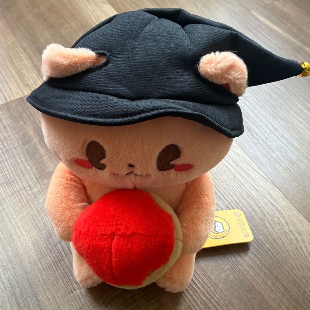 Peach Plush Cat Holding Red Apple with Black Hat